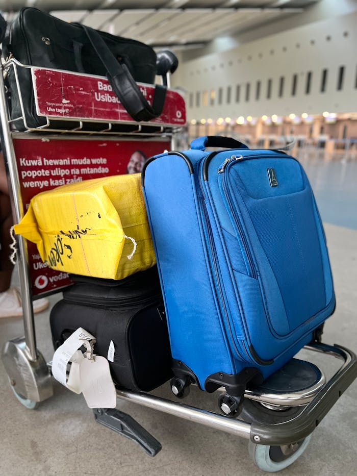 Luggage on trolley in Dar es Salaam Airport, Tanzania, showcasing travel preparation and mobility.